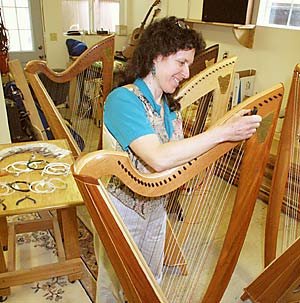 Sharon Thormahlen strings a harp